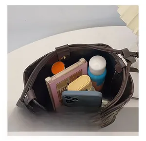 Internal view of dark brown quilted bucket bag showing spacious storage capacity