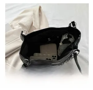 Interior storage space of the black quilted tote bag showing large capacity and pockets