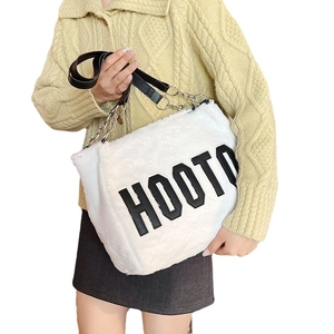 White faux fur tote bag with HOOT lettering and black chain shoulder strap