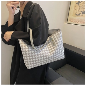 Large houndstooth tote bag shown on shoulder to display size and stylish fit