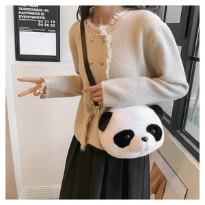 Close-up of cute panda plush bag worn by a model showing soft texture and compact size