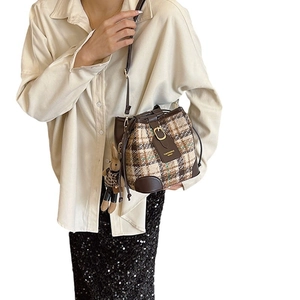 Retro plaid tweed bucket bag with dark brown leather straps and a cute bunny charm