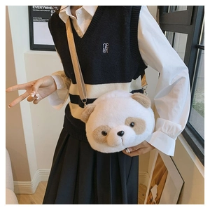 Detail view of a cute plush panda crossbody bag with soft faux fur and adjustable strap
