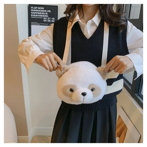 Detail of cute white plush panda crossbody bag with soft faux fur texture and straps