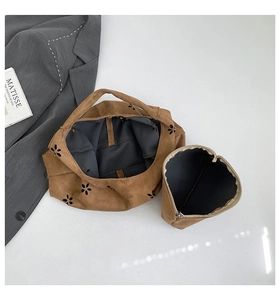 Detail of caramel suede tote featuring floral laser-cut patterns and removable pouch