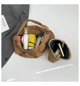 Interior view of brown suede tote with laser-cut floral detail showing storage capacity