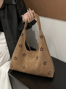 Brown faux suede tote bag with floral laser cut design and integrated shoulder strap