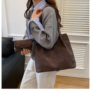 Detail of dark brown faux suede tote bag set with matching inner pouch for women