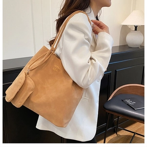 Detail of camel faux suede tote bag with small zipper pouch and embossed logo