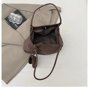Detailed view of brown suede tote bag with matching coin purse and magnetic clasp closure