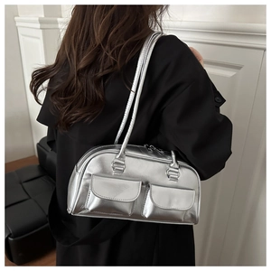 Detail of metallic silver shoulder bag showing the glossy finish and utility pockets
