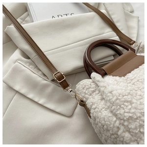 Détails du sac à main en peluche douce avec garniture en cuir brun et boucles dorées