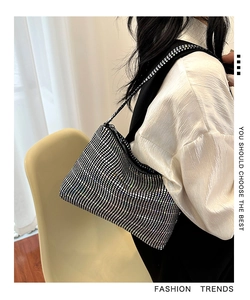 Detail view of sparkly rhinestone shoulder bag on model with elegant evening fashion style