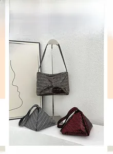 Close-up of sparkling sequined evening bags in rectangular and triangle shapes with glitz