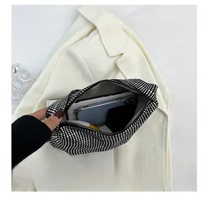 Detail view of rhinestone clutch bag capacity holding a smartphone and makeup items