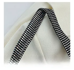 Close-up of decorative shoulder strap with iridescent sequins and sparkling rhinestones