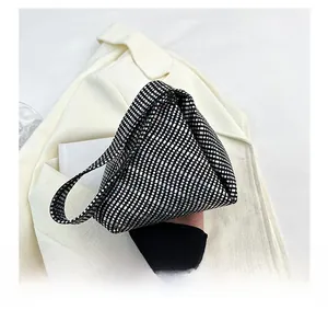 Detail showing high-density silver sequins and triangular structure of this clutch bag