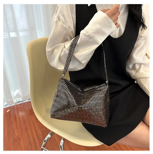 Detail showing shimmering silver rhinestone surface and V-pattern on the shoulder bag