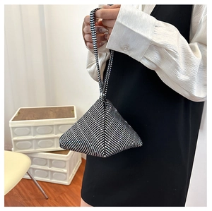 Detail of silver rhinestone pyramid evening bag with shimmering crystals and top handle