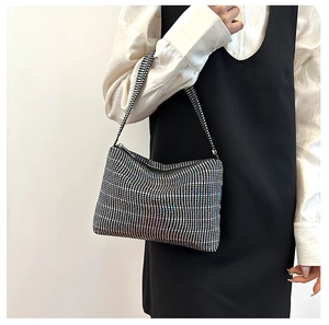 Close-up of sparkling silver rhinestone shoulder bag on model for party evening style