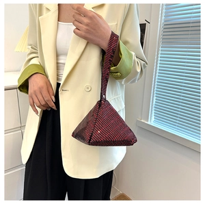 Close-up of a luxury triangle evening bag with sparkling red and black sequins for women
