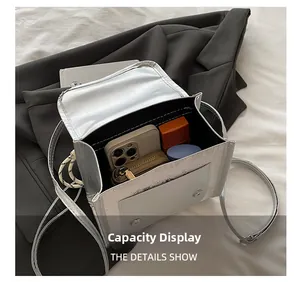 Silver metallic square bag interior showing capacity for phone and essentials