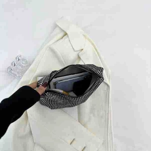 Detail shot of black rhinestone handbag showing interior capacity for a smartphone