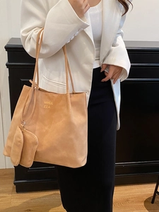 Large capacity camel tote bag with gold lettering shown on shoulder for office commute