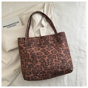Close-up of leopard print tote bag placed on a chic blazer for a stylish fashion look
