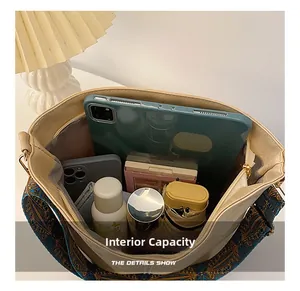 Top view of large capacity bucket bag interior holding tablet, phone, and daily essentials