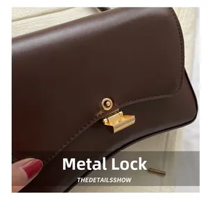 Detailed close-up of premium dark brown leather bag with elegant gold metal square lock