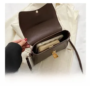 Internal view of brown leather shoulder bag showing large capacity for phone and wallet