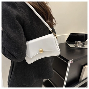 Close-up of minimalist white leather baguette bag with a sleek gold metal buckle