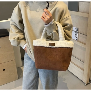 Detail of soft lamb wool trim and brown suede fabric on this stylish winter tote bag