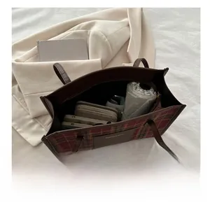 Interior view of checkered tote bag showing capacity for wallet, phone and umbrella