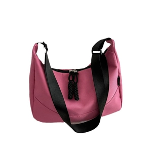 Pink nylon underarm bag with black shoulder strap and large capacity crescent design