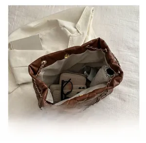 Top view of spacious interior of brown quilted tote bag showing large capacity storage