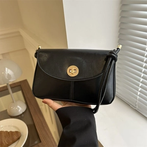 Retro black leather crossbody bag for women with a gold metal twist lock closure