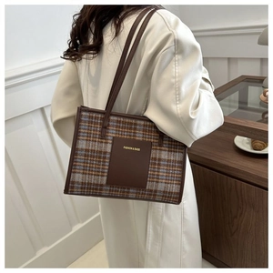 Detail of checkered tote bag with leather straps and Fashion & Bags leather patch