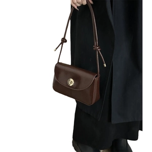 Retro dark brown leather underarm bag with gold lock buckle and knot strap detail