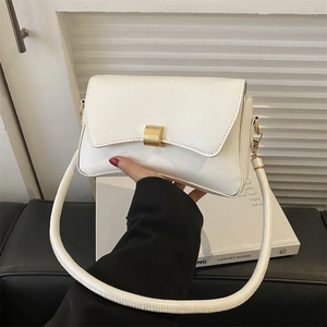 Modern white matte leather baguette bag with thick gold clasp and tubular shoulder strap