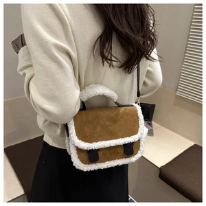 Vintage brown suede handbag with white faux fur trim shown on model as a crossbody bag