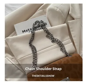 Detailed shot of brown leopard texture crossbody bag with gold chain strap on beige blazer