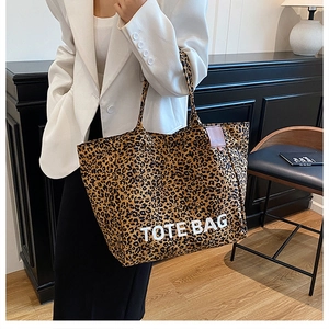 Detailed view of the leopard print tote bag with bold TOTE BAG lettering on fabric