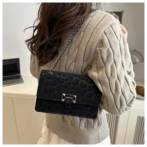 Detail of leopard print velvet shoulder bag featuring gunmetal chain and square lock
