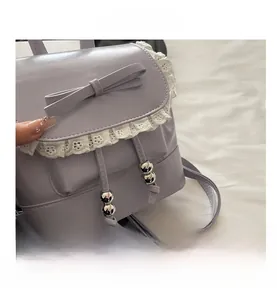 Detailed shot of purple mini backpack featuring lace trim and bowknot accents