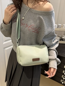 Minimalist light green nylon crossbody bag for women with adjustable fabric strap