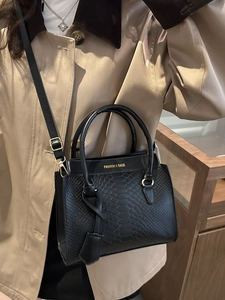 Elegant black python texture tote bag for women with gold logo and shoulder strap