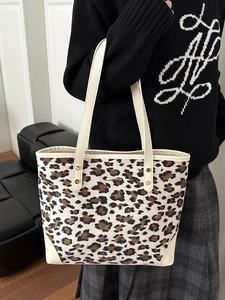 Fashionable leopard print tote bag with cream handles and metal logo for daily commute