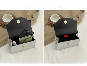 Detailed view of silver evening bag interior capacity with magnetic gold clasp